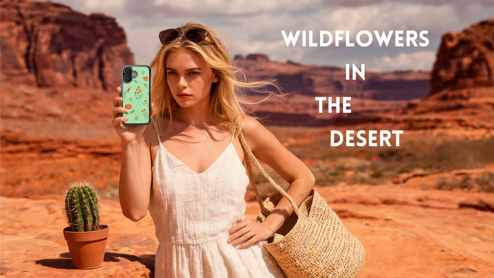 A woman in a white dress stands in a desert landscape holding a phone with a green floral case, carrying a woven straw bag. Large text on the right reads 'WILDFLOWERS IN THE DESERT'.